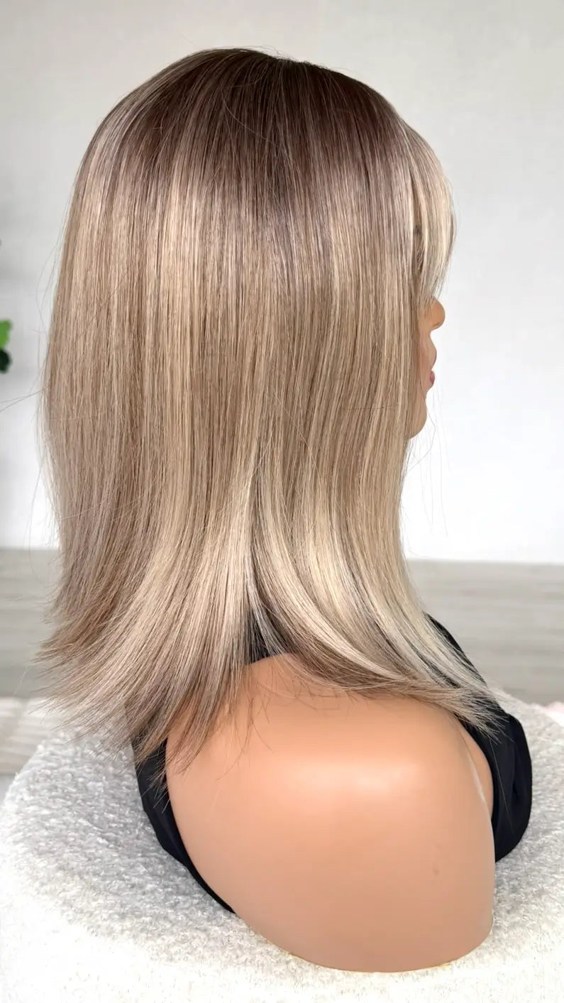 side view of shimmery blonde hair, synthetic heat safe hair, fringe.