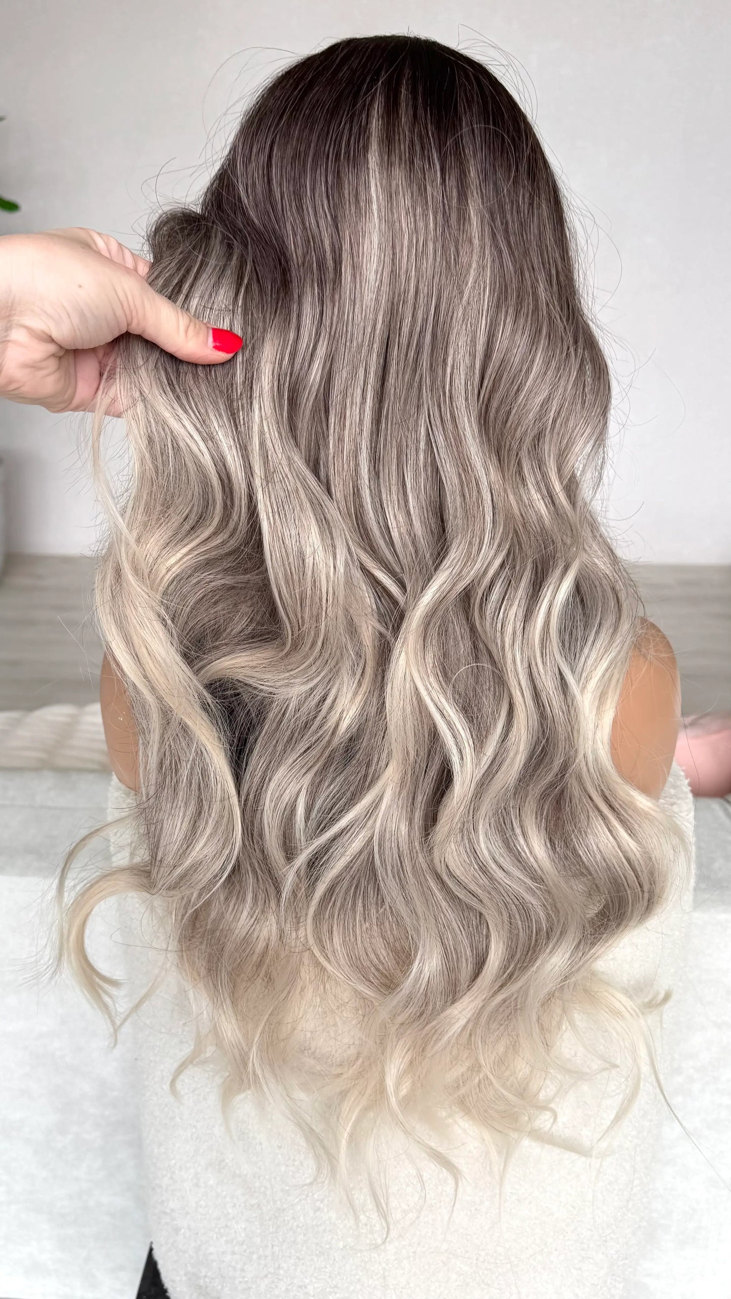 back view, holding hair, ombre hair dark to light, silver ash blonde synthetic wig.