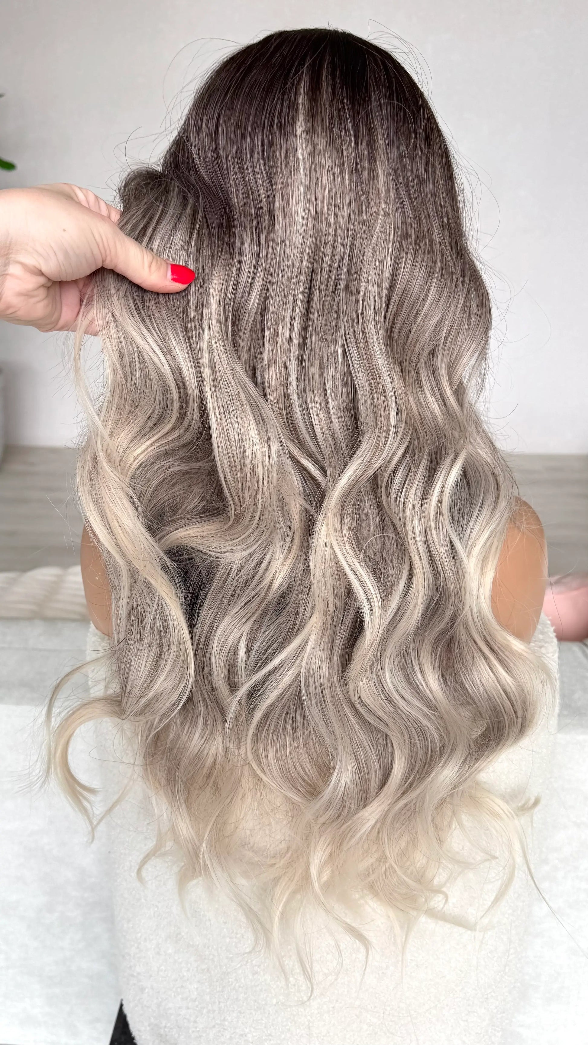 back view, holding hair, ombre hair dark to light, silver ash blonde synthetic wig.