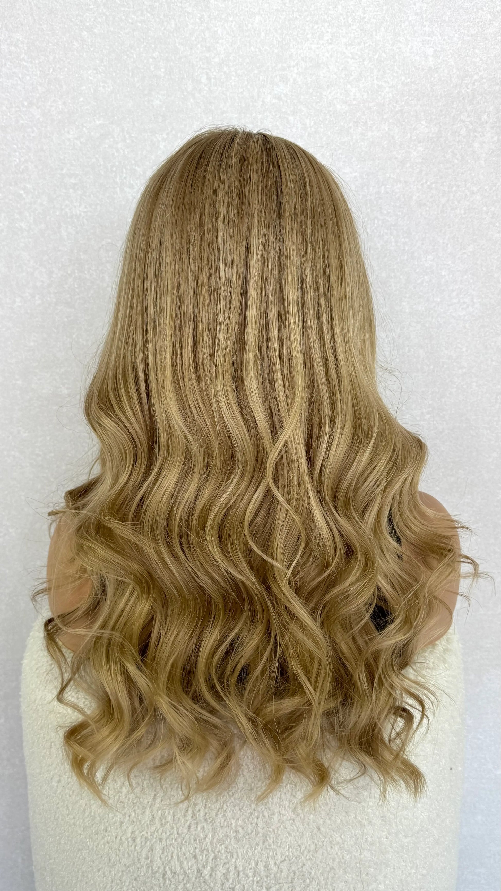 Back view of a 22-inch lace front wig in golden blonde, revealing natural-looking layers and movement