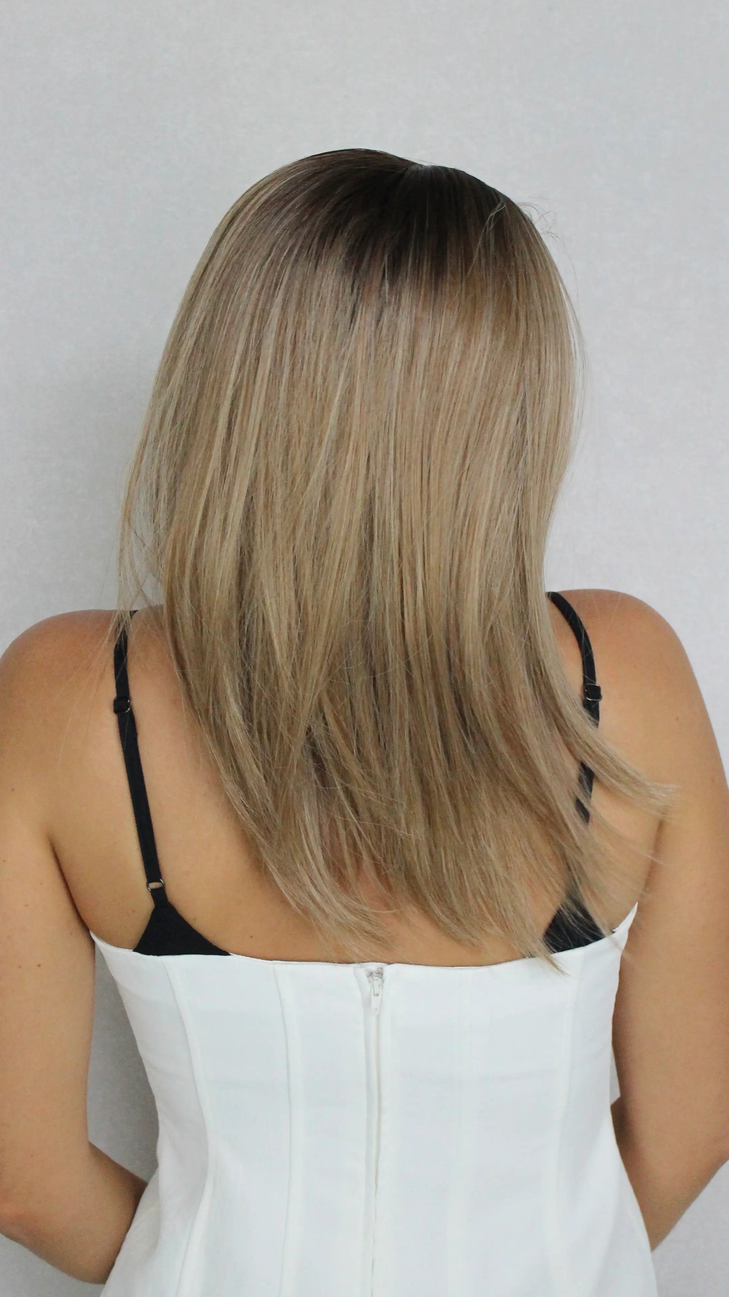 sarah t-part lacefront wig from the back, showing length and cut, blended bronde hair.