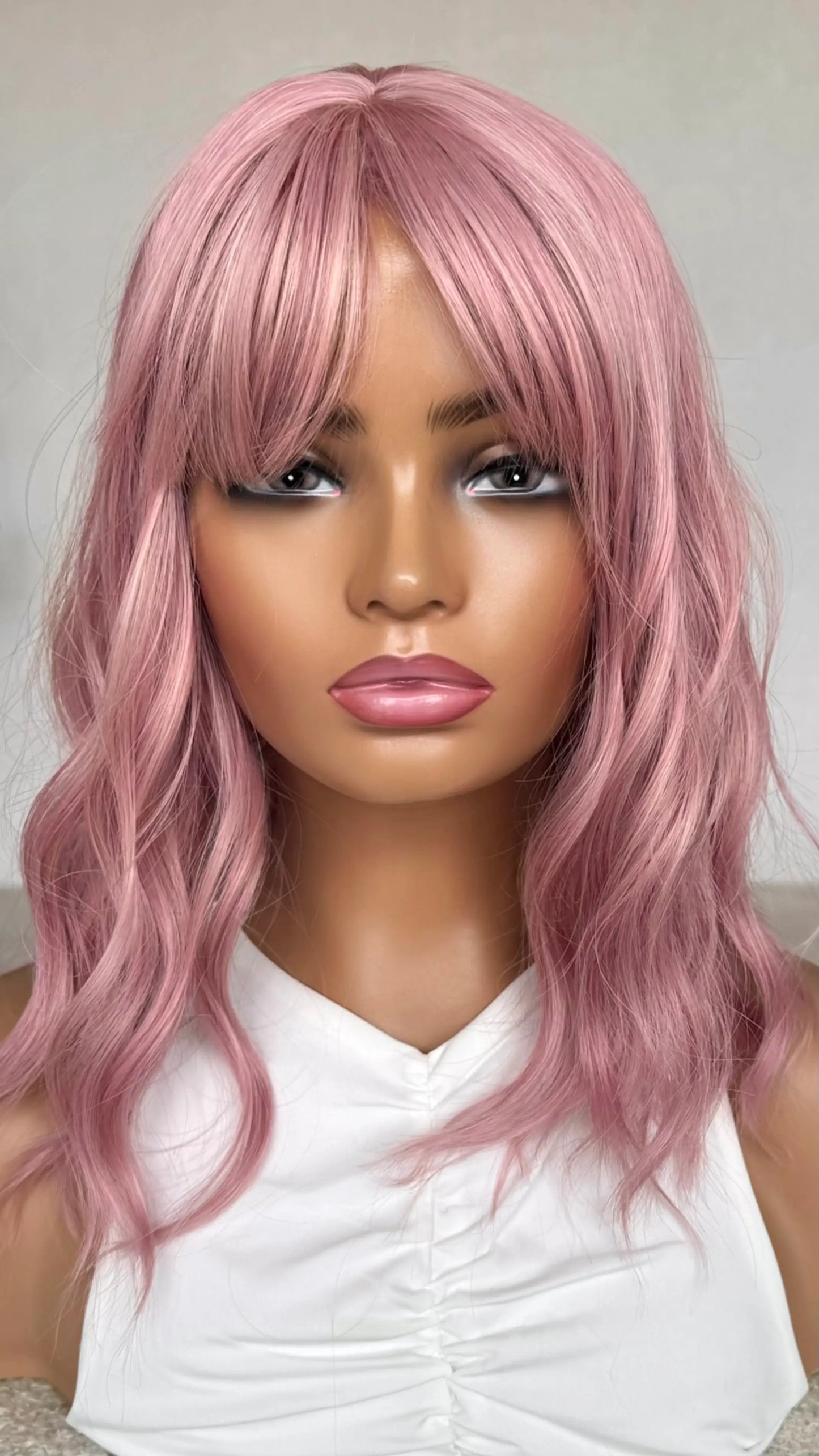 Pearl Pink Wig front view, fringe parted to the side, heat safe synthetic hair. wavy bob.