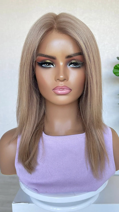 A 16-inch human hair lace front wig in soft rose gold blonde, featuring a luminous blend of pink and golden hues for a radiant look.