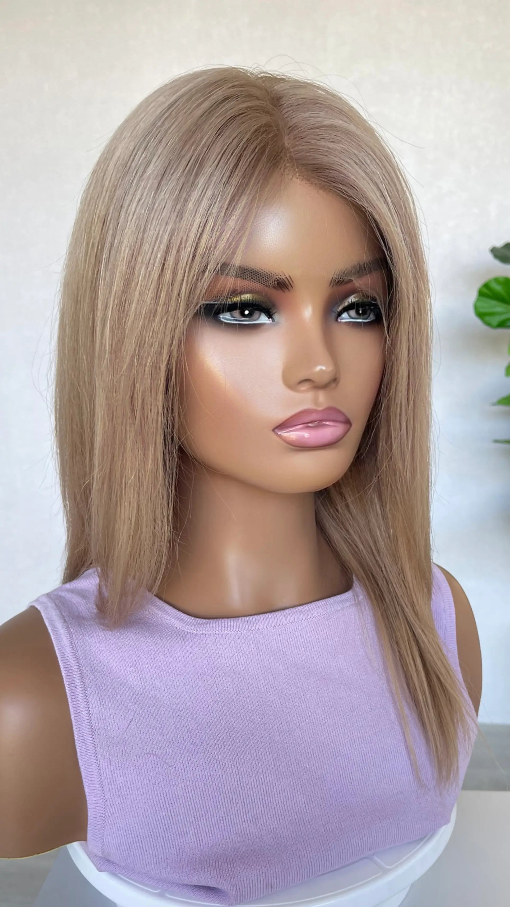 Side view of the Serena wig, showcasing its delicate rose gold blonde shade with subtle depth and natural movement.