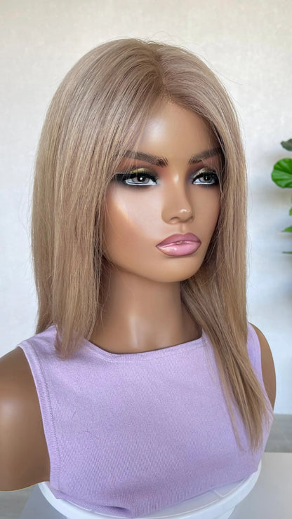 Side view of the Serena wig, showcasing its delicate rose gold blonde shade with subtle depth and natural movement.