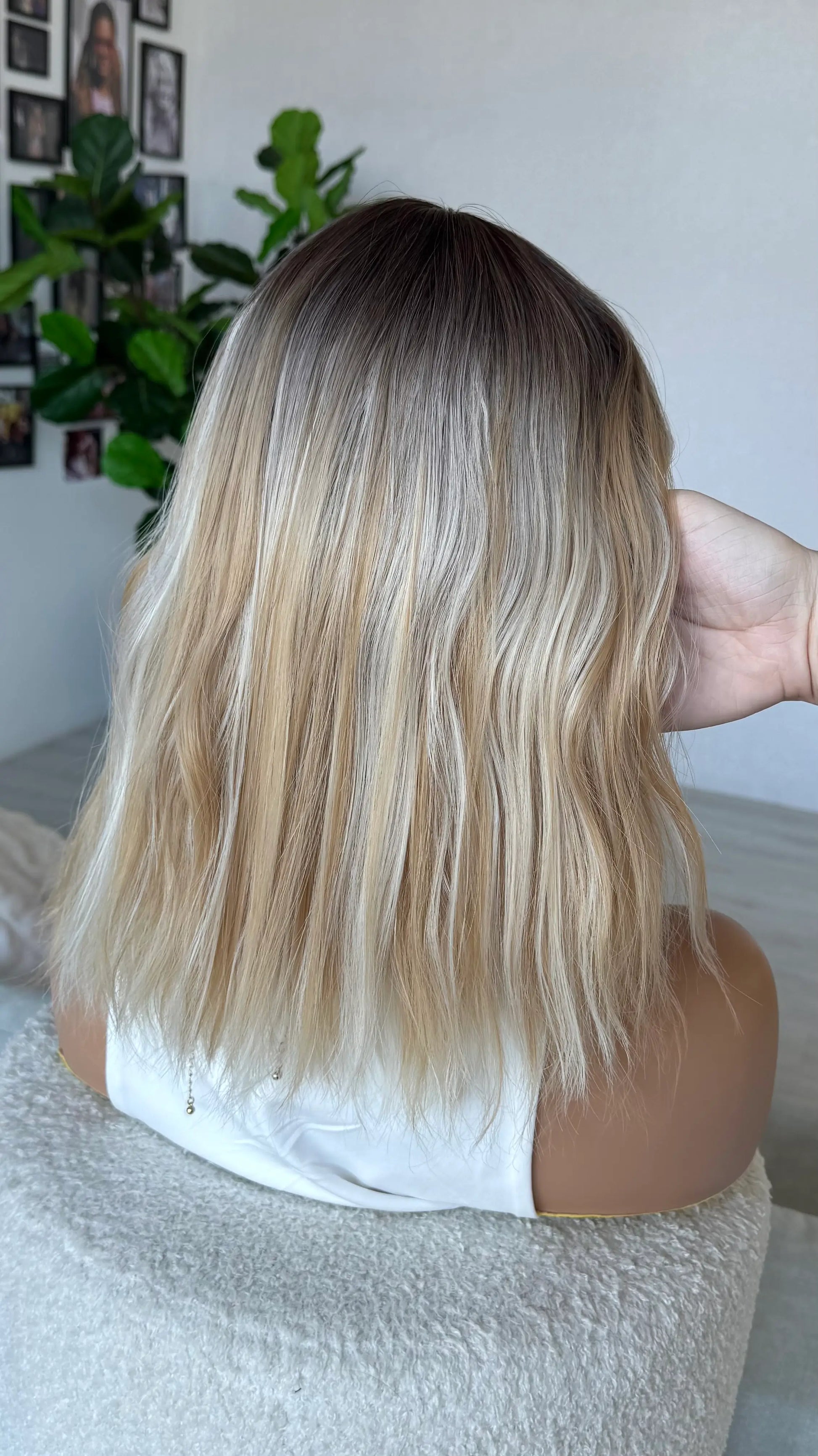 back view, dark root to light blonde hair, mixed tones blonde wig. heat safe synthetic hair.