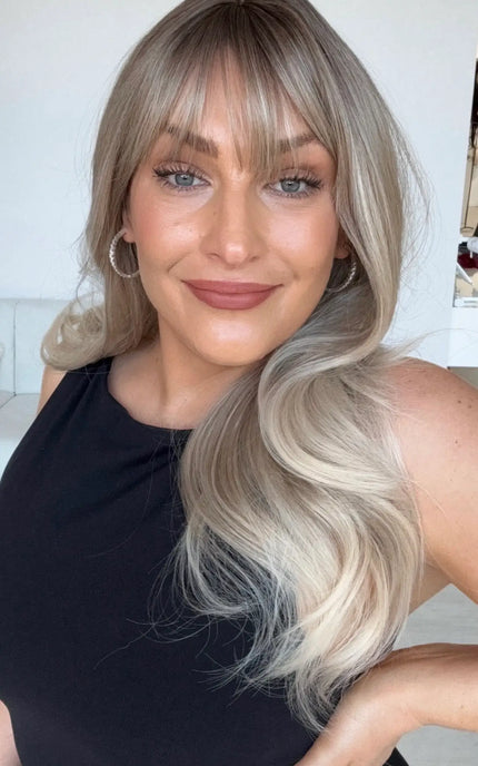 ash blonde ombre with light blonde ends, light curl with middle part and wispy fringe.