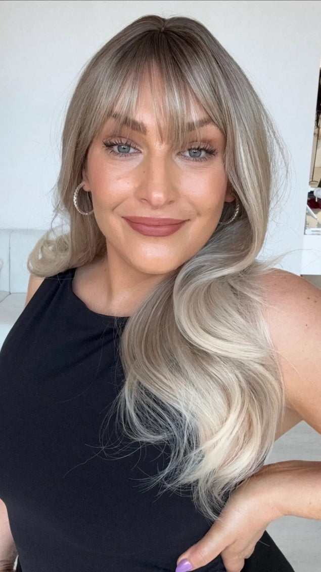 ash blonde ombre with light blonde ends, light curl with middle part and wispy fringe.