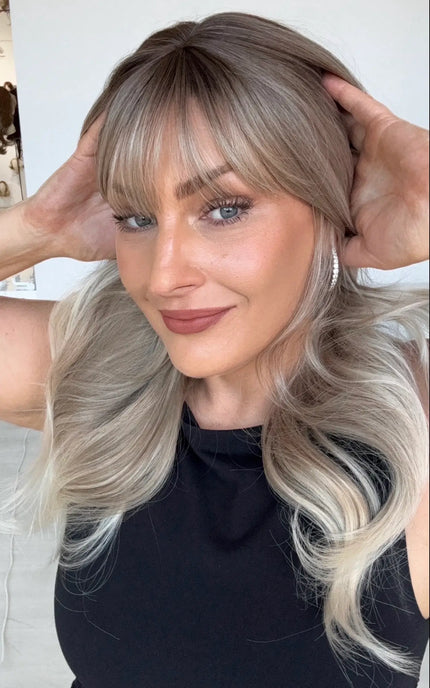 ash blonde ombre with platinum blonde ends and middle part with wispy fringe and face framing layers. heat safe glueless wig.