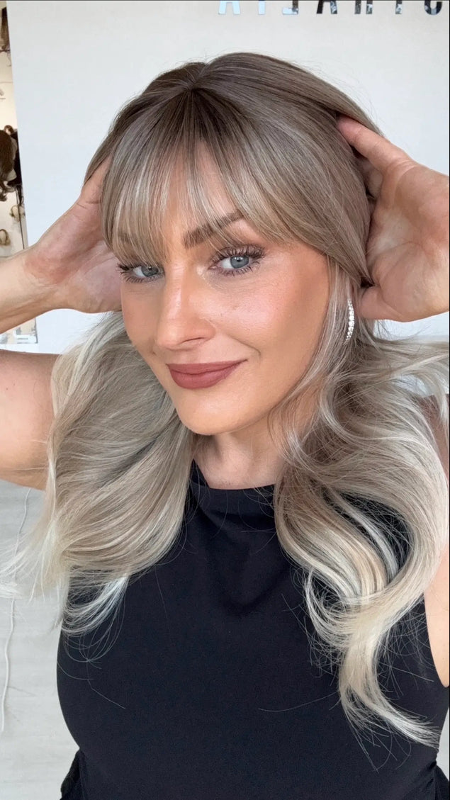 ash blonde ombre with platinum blonde ends and middle part with wispy fringe and face framing layers. heat safe glueless wig.