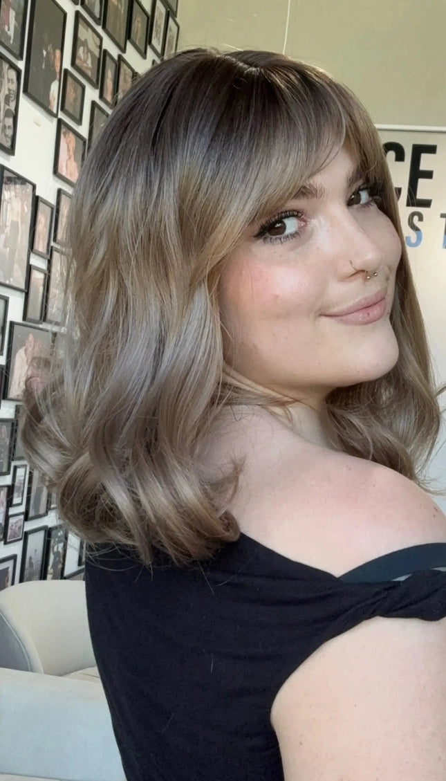 heat safe glueless synthetic wig, middle part with fringe parted to the side.