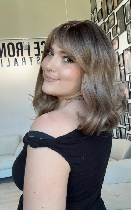 heat safe glueless synthetic wig, middle part with fringe parted to the side.