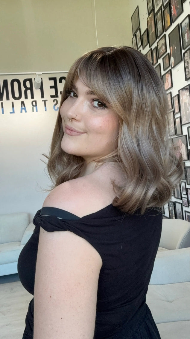 heat safe glueless synthetic wig, middle part with fringe parted to the side.