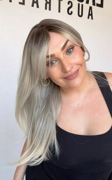 ash ombre middle part with layers and curtain bangs. platinum ash ends with dark root.