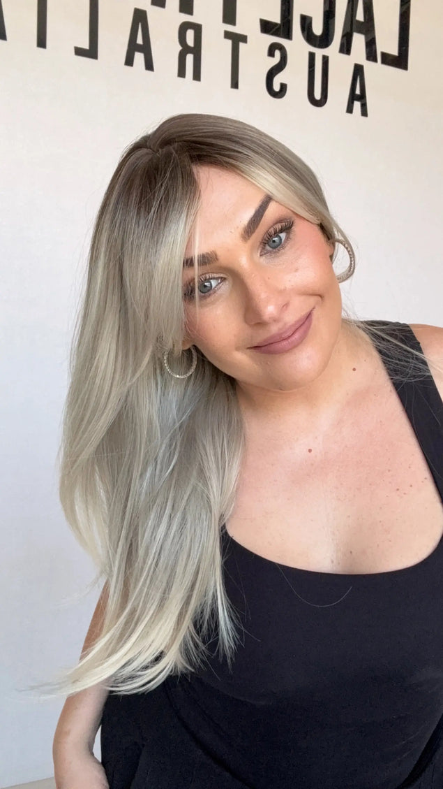 ash ombre middle part with layers and curtain bangs. platinum ash ends with dark root.