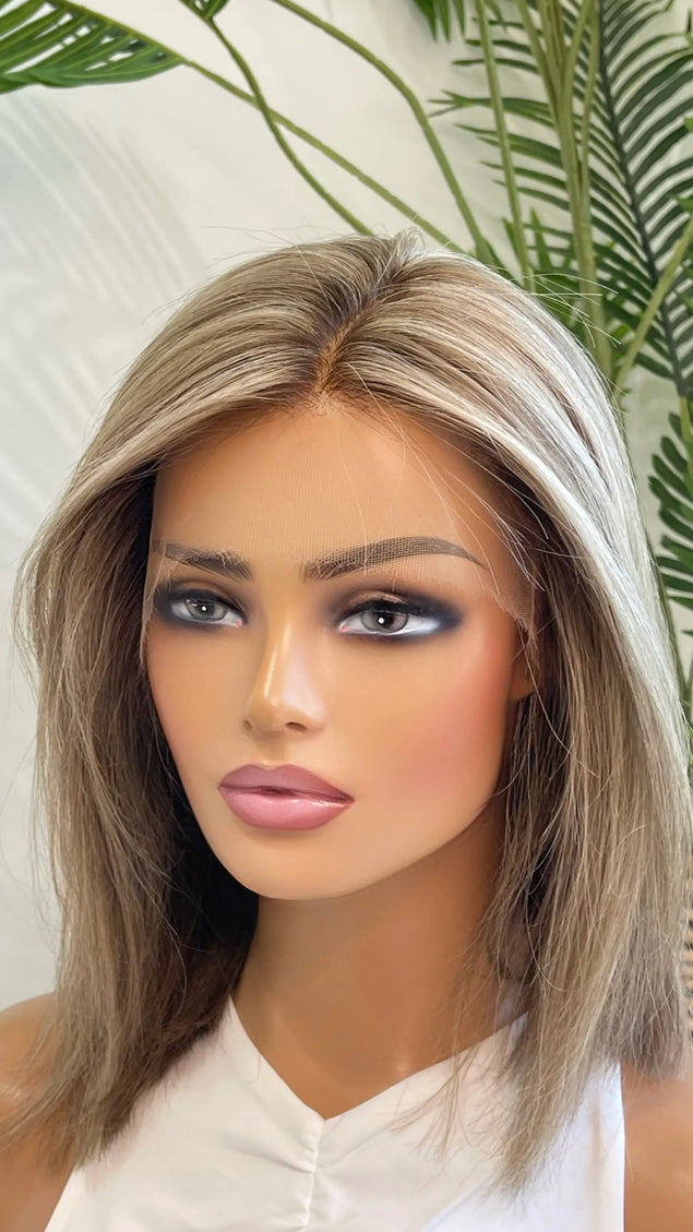 Side view of the Lily wig, showcasing its expertly blended beige blonde shade with delicate lowlights for depth and movement