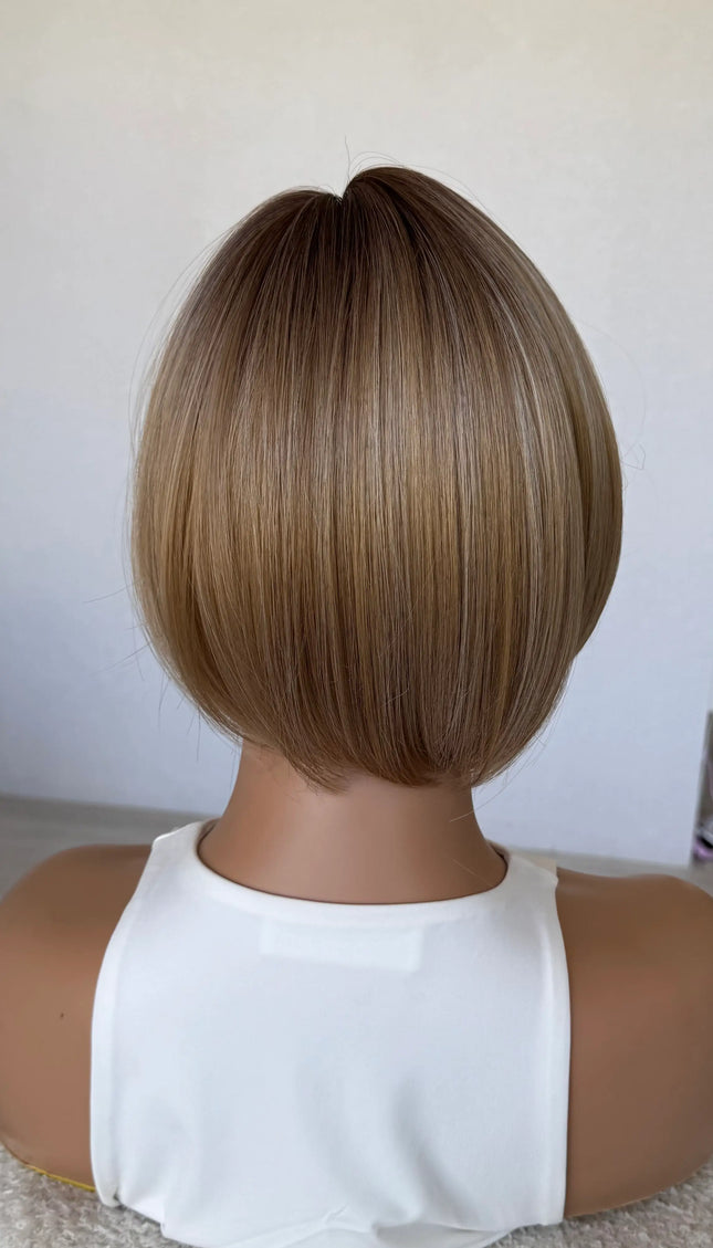 back view 10 inch synthetic hair topper, mixced warm toned blonde.