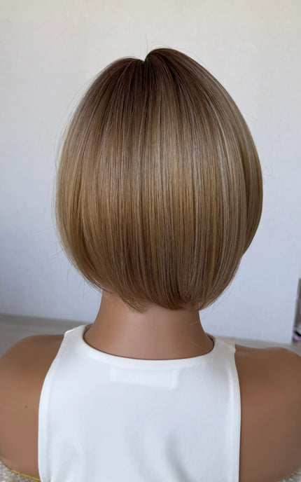 back view 10 inch synthetic hair topper, mixced warm toned blonde.