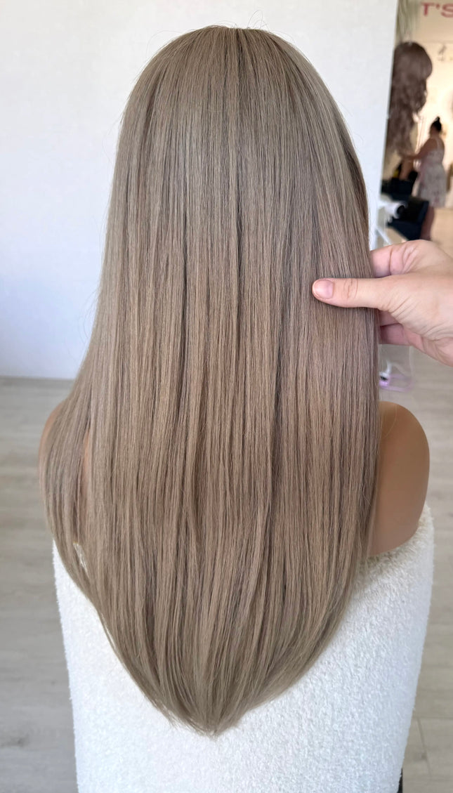 from behind holding long straight hair 24 inch length ash blonde hair wig.