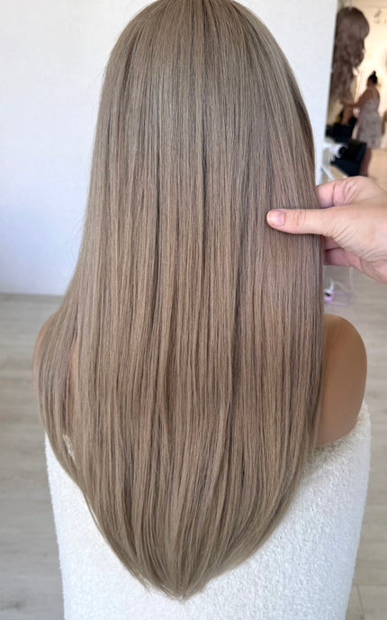 from behind holding long straight hair 24 inch length ash blonde hair wig.