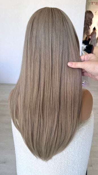 from behind holding long straight hair 24 inch length ash blonde hair wig.