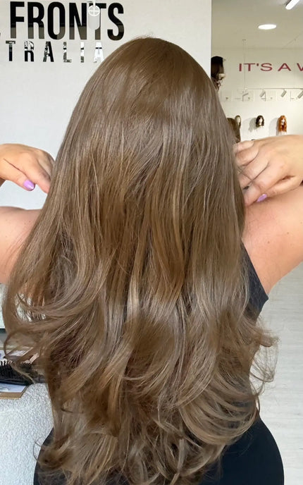 back view showing soft light brown hair with bouncy layers throughout and flicky ends.