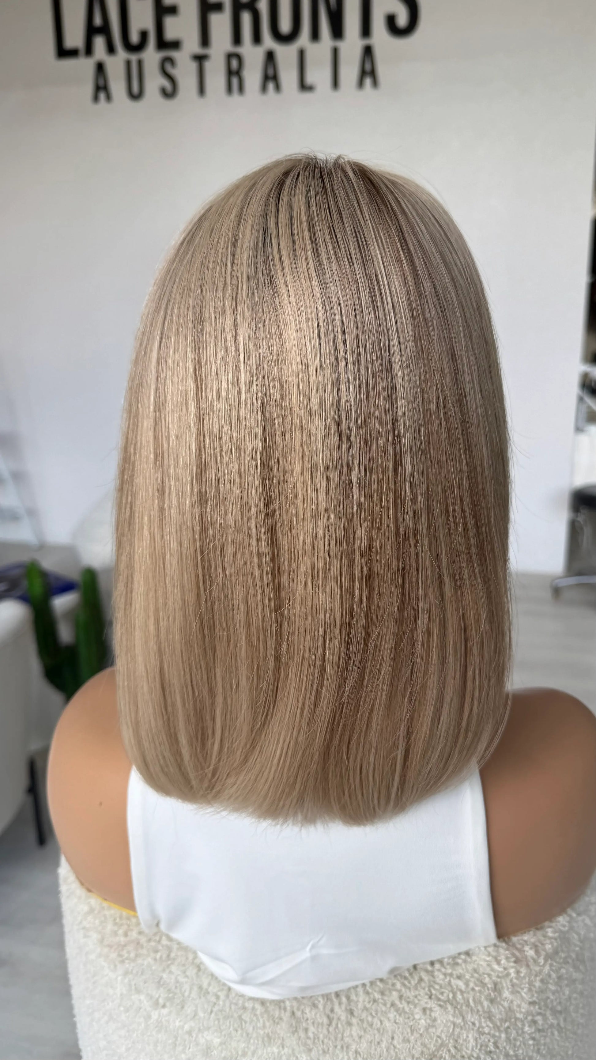 lace wig from back view, 12 inch length bob. sandy beige blonde with ash undertones, cathy wig.