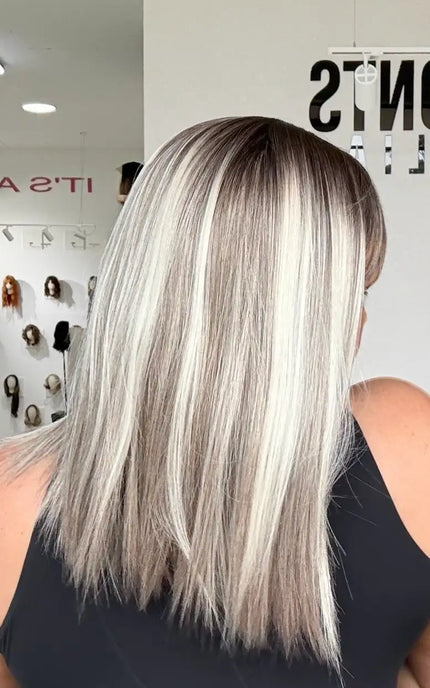 close up shot of highlighted light blonde platinum highlights and darker shadow root, ash grey mid tone, straight hair.