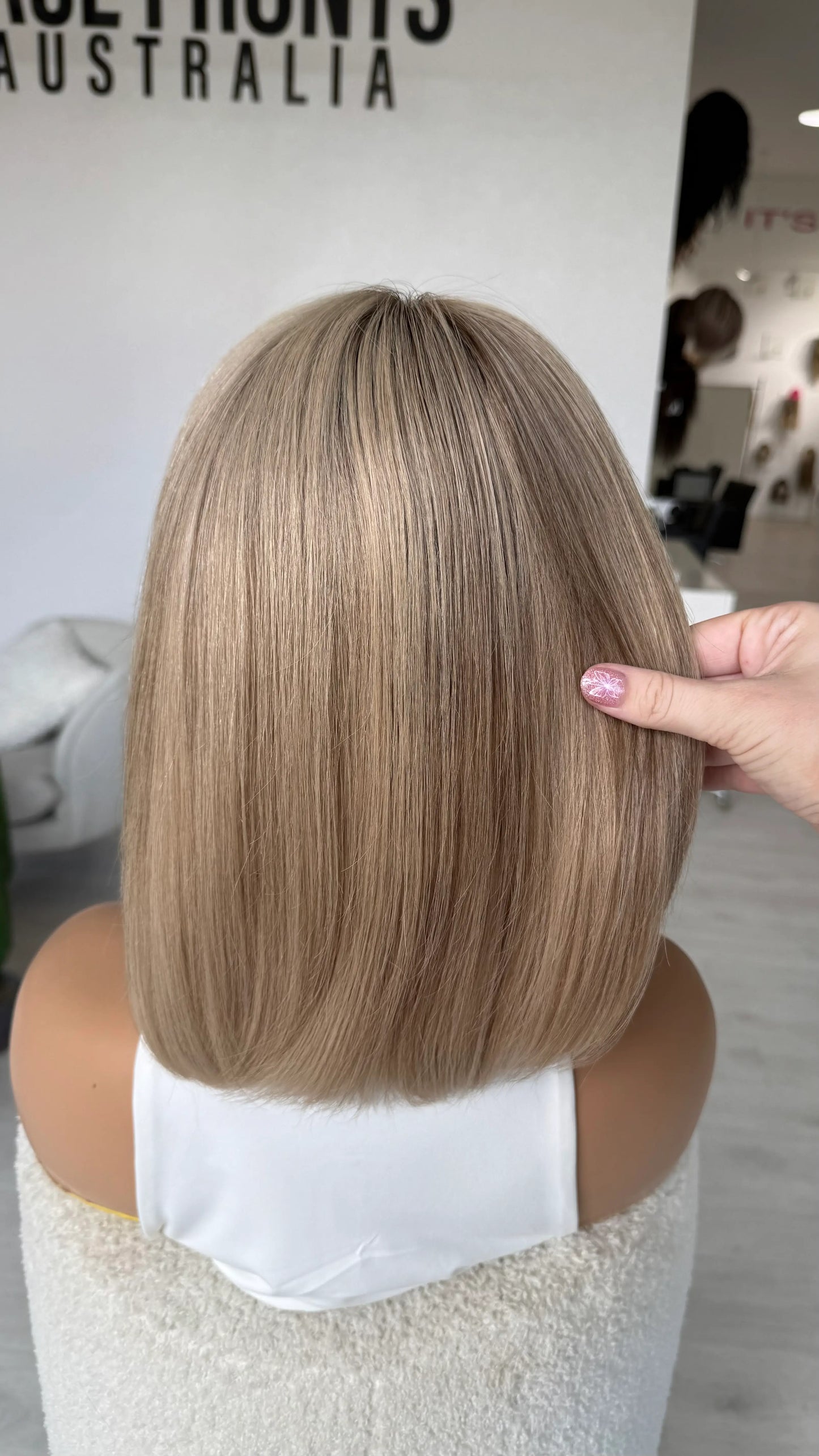back view holding blonde hair, darker root, human hair lace front wig, australia wigs. 