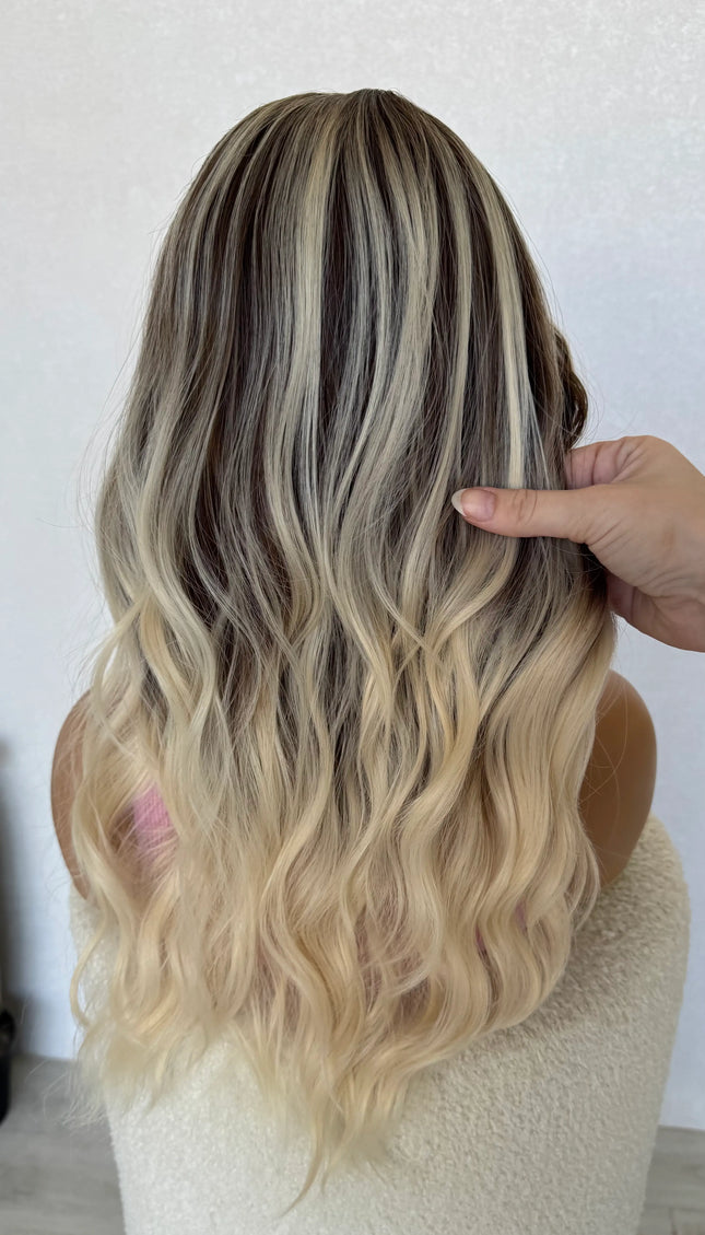 back view holding hair, ash brunette with platinum highlights throughout.