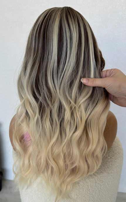 back view holding hair, ash brunette with platinum highlights throughout.
