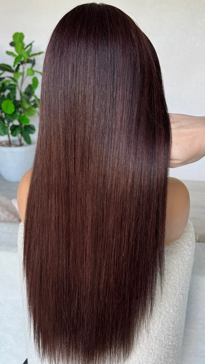 back view holding dark hair, red highlights. holding the 24 inch hair, lacefront wig natural.