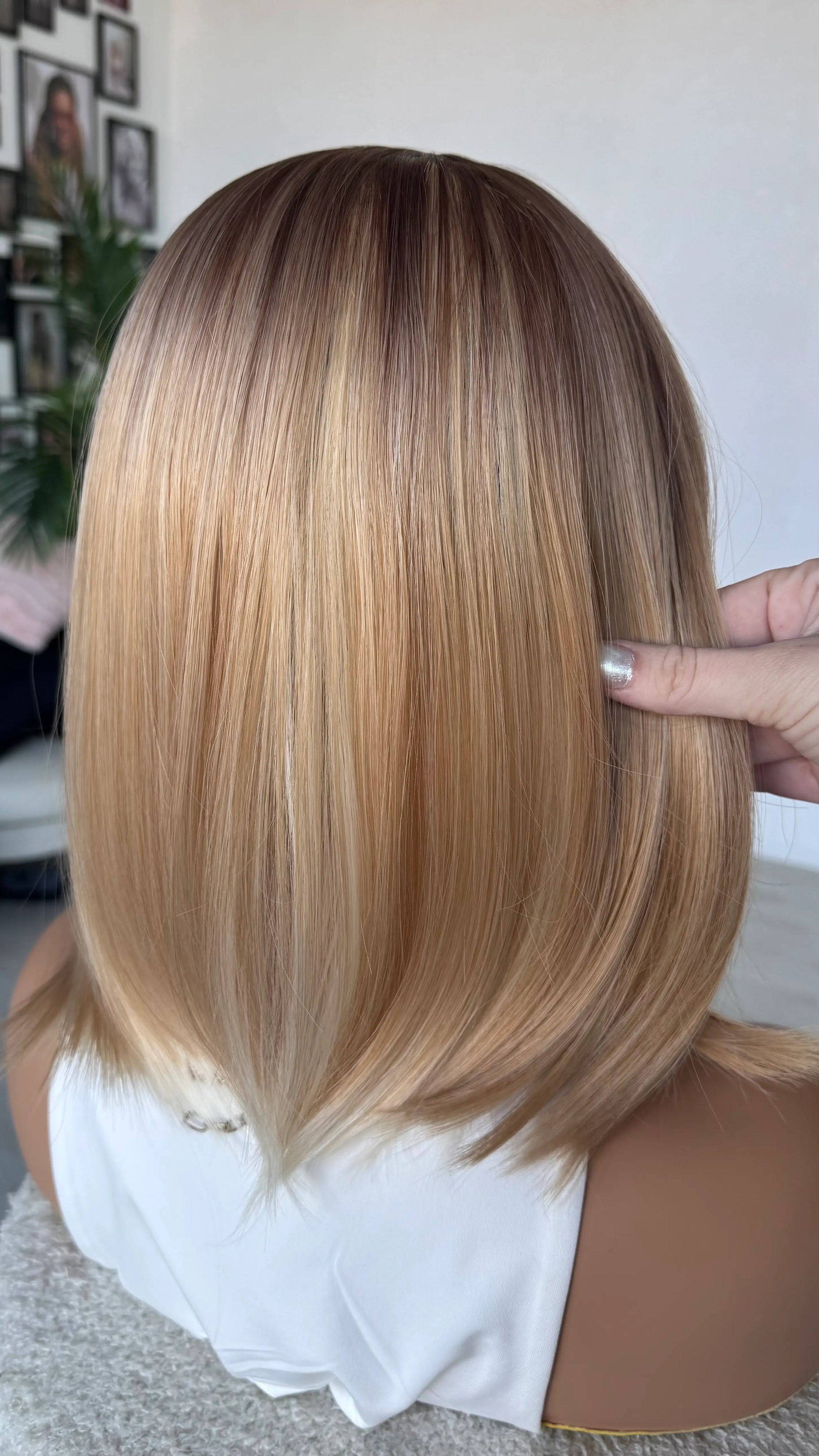 Back view holding ombre bob hair, middle part, heat safe synthetic hair.