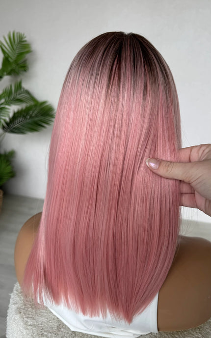 back view holding pink ombre hair straight hair wig, heat safe glueless wig.