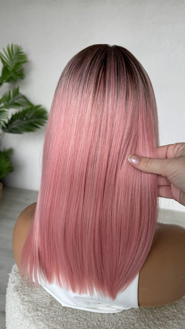back view holding pink ombre hair straight hair topper, heat safe glueless topper.