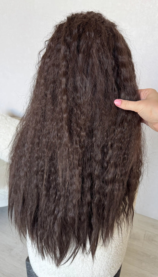 back view holding long dark brown hair curly waves.