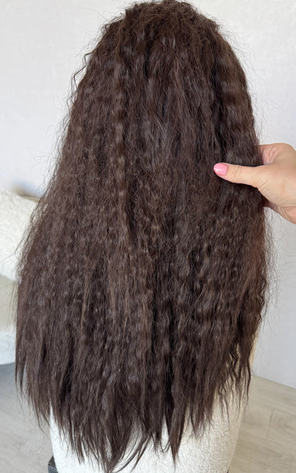 back view holding long dark brown hair curly waves.