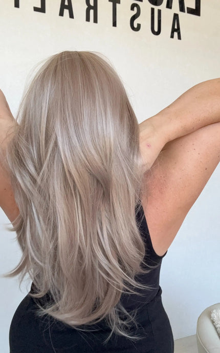 lilac toned synthetic hair, layered with curtain bangs and middle parting.