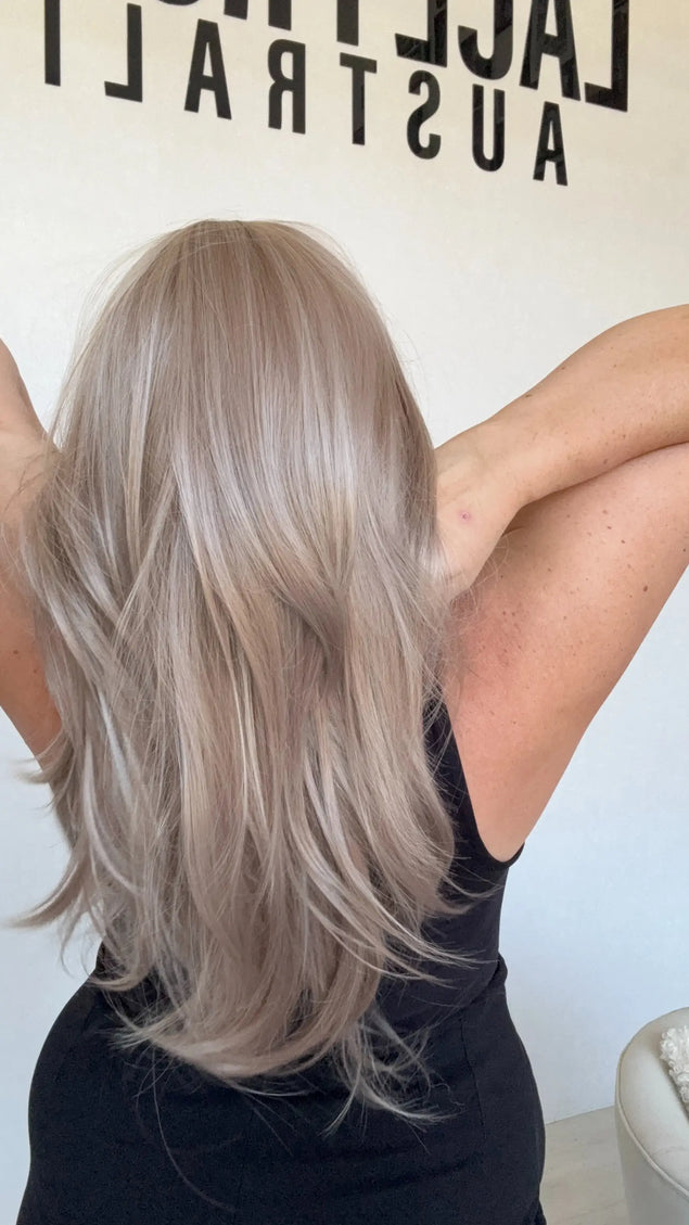 lilac toned synthetic hair, layered with curtain bangs and middle parting.