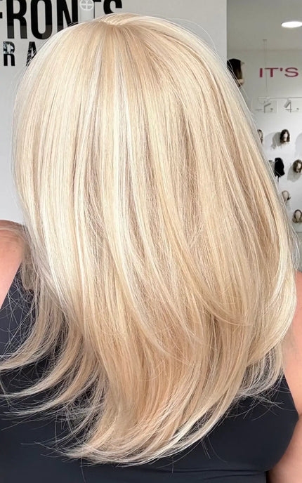 up close back shot showing light blonde hair colour with middle part and soft layers.