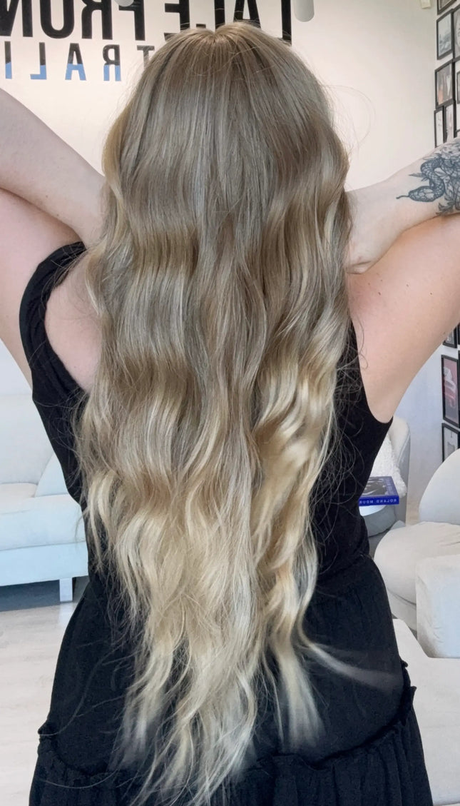 long wavy blonde hair with highlights, middle parting with fringe. heat safe glueless wig australia.