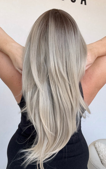 long ombre layered hair, ash toned, middle part with curtain bangs.