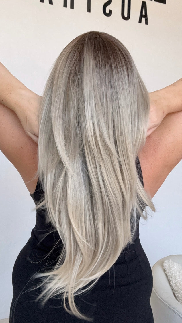 long ombre layered hair, ash toned, middle part with curtain bangs.