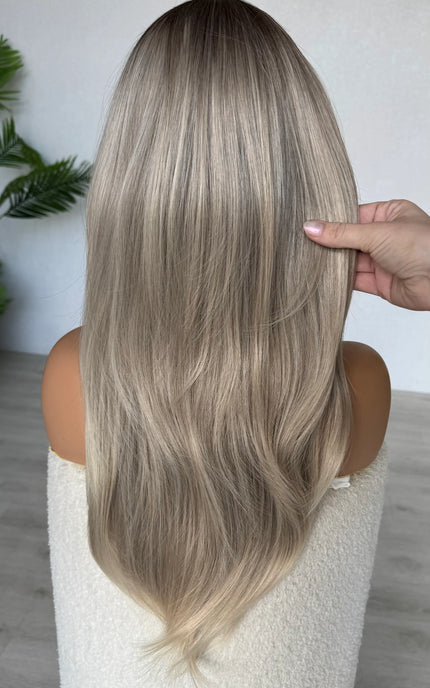 back view natalia holding the ash ombre hair, middle part with curtain bangs.