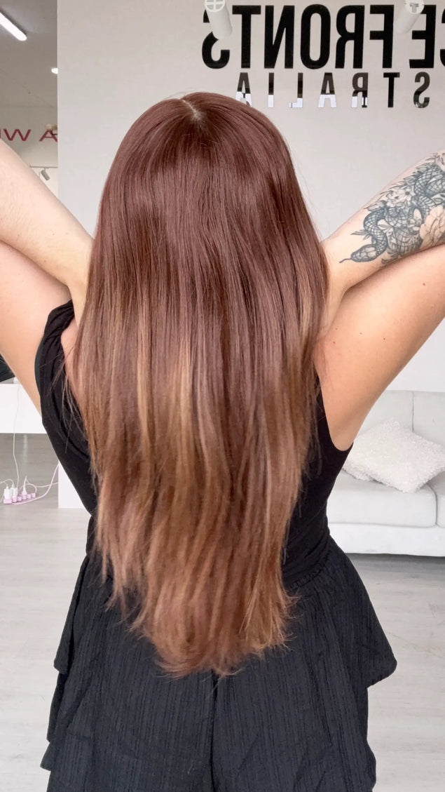 a back view showing long length straight hair with a middle part. soft fade of colour to ends.