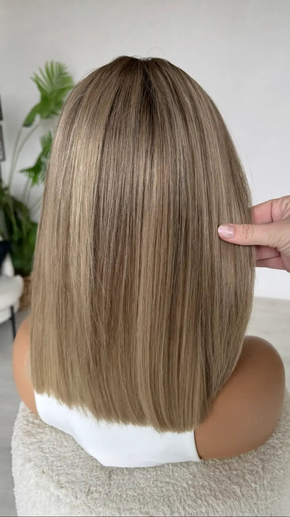 human hair lacefront wig from the back view, holding the multi toned hair, 14 inch in length, straight cut.