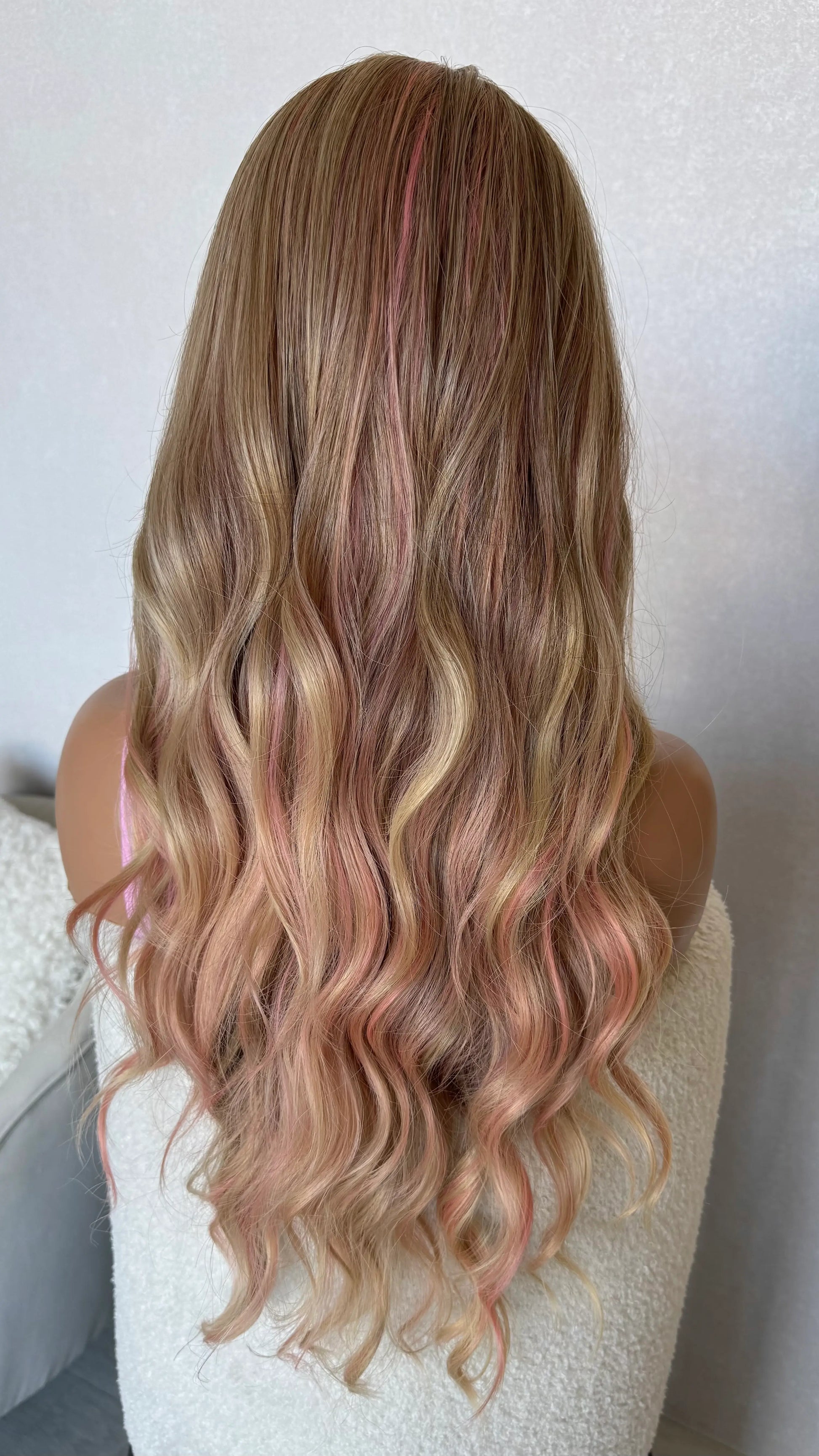 wavy pink and blonde fringe wig, middle part with long hair from back view.