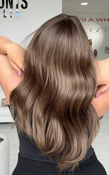 back view of soft wave through ash brown coloured hair, middle part.