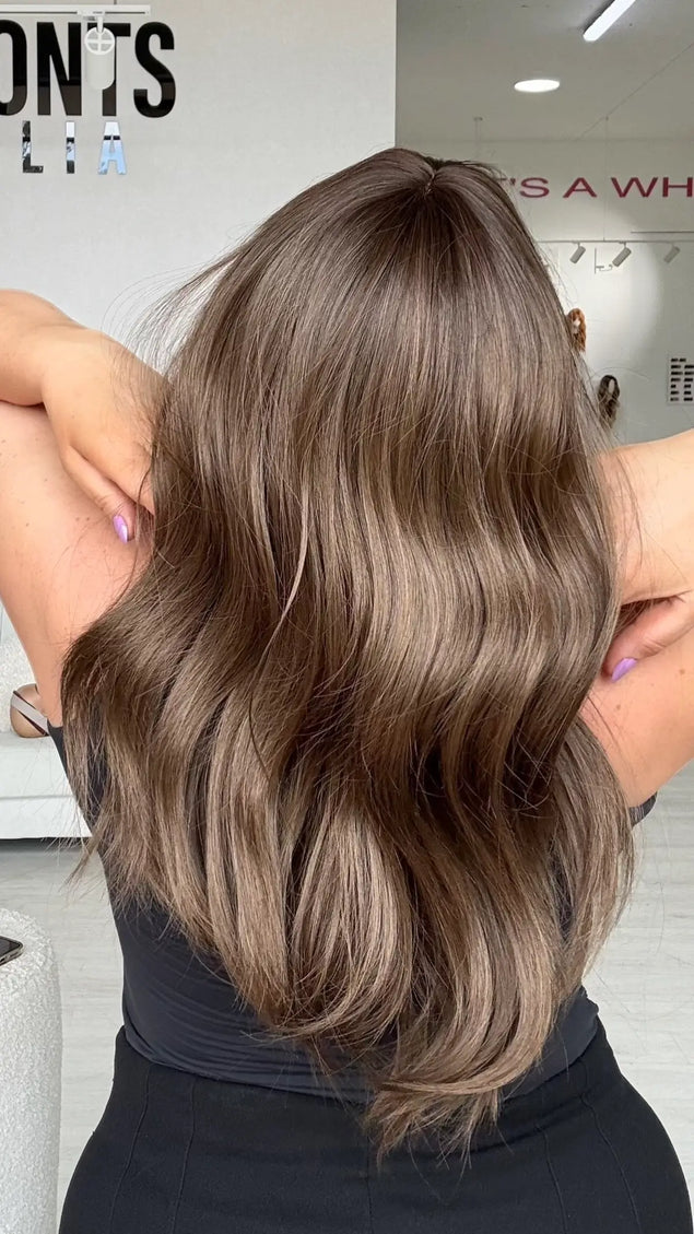back view of soft wave through ash brown coloured hair, middle part.
