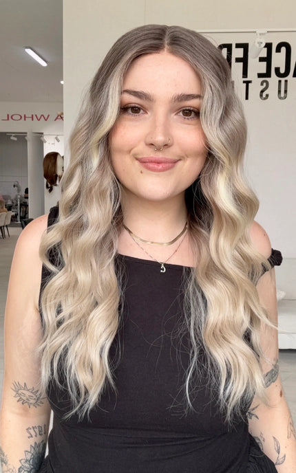 beachy wave long length blonde hair with cool dark blonde root, realistic hairline with a glueless cap and adjsutable straps. heat safe blonde hair for easy styling and a colour that doesnt fade!